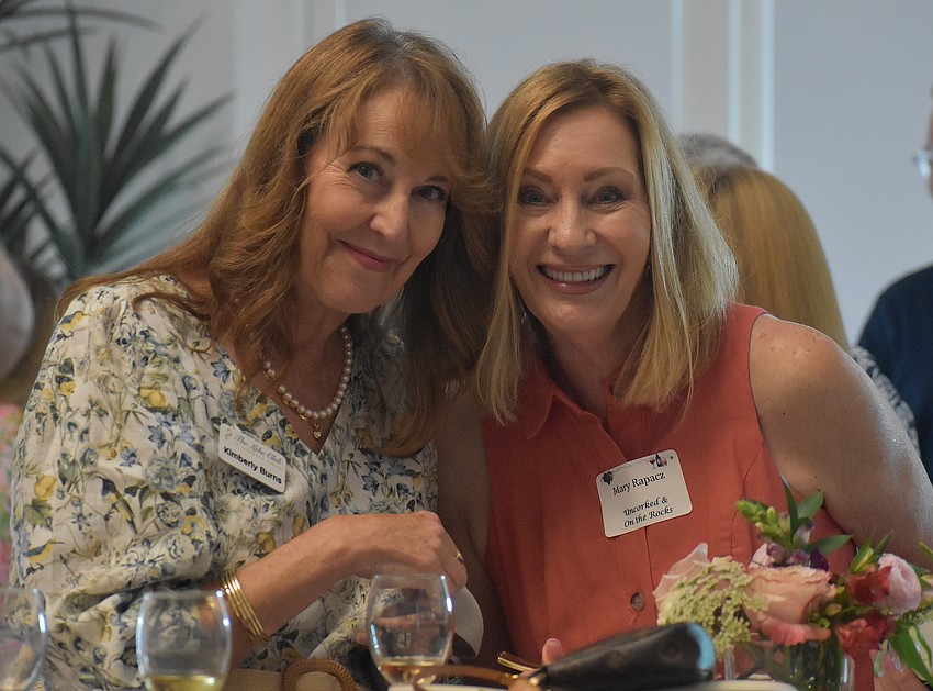 Kimberly Burns and Mary Rapacz socialize at the Uncorked & On the Rocks fundraiser April 30.